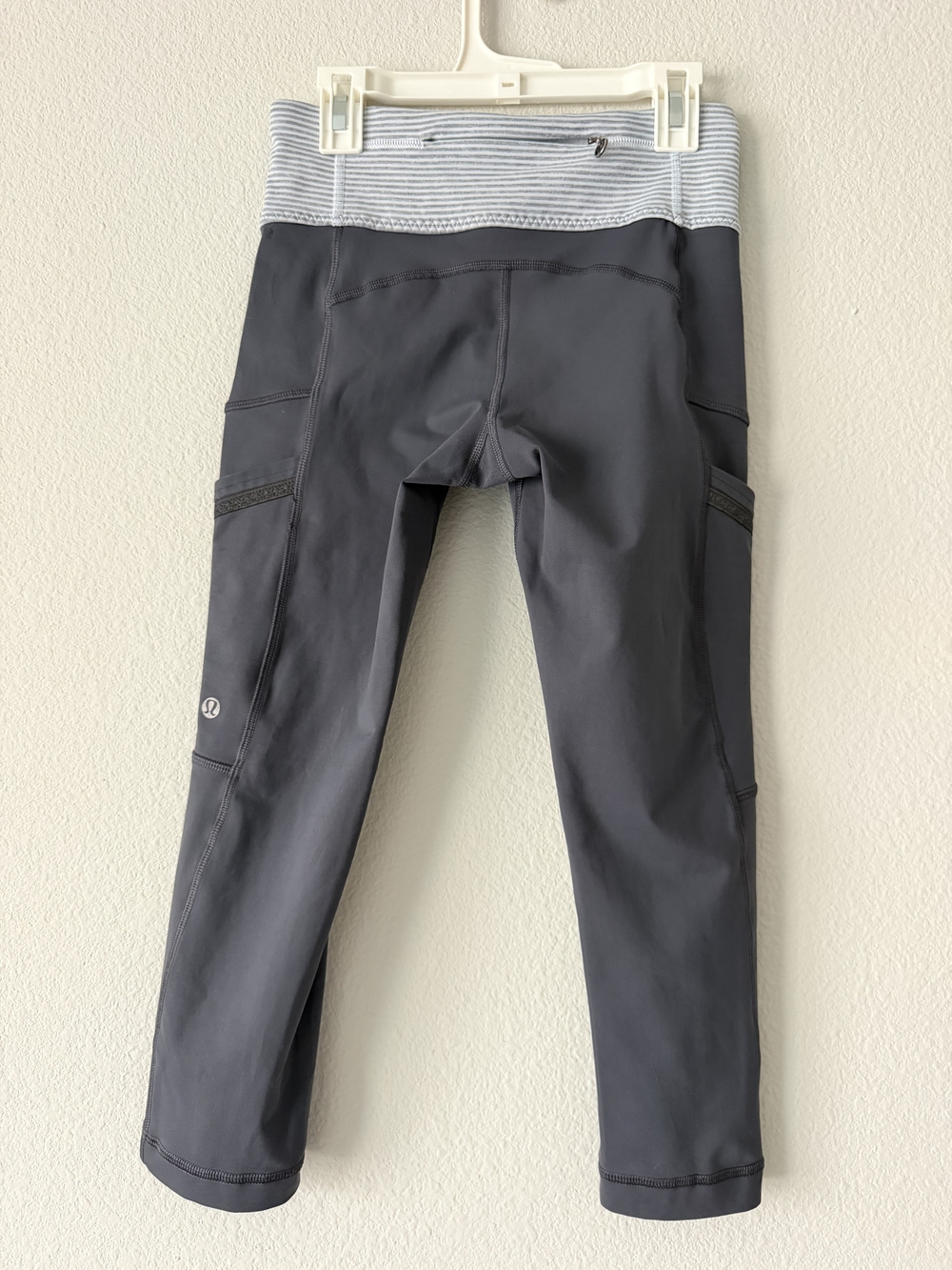 lululemon cropped athletic leggings in a dark gray/charcoal color with a contras